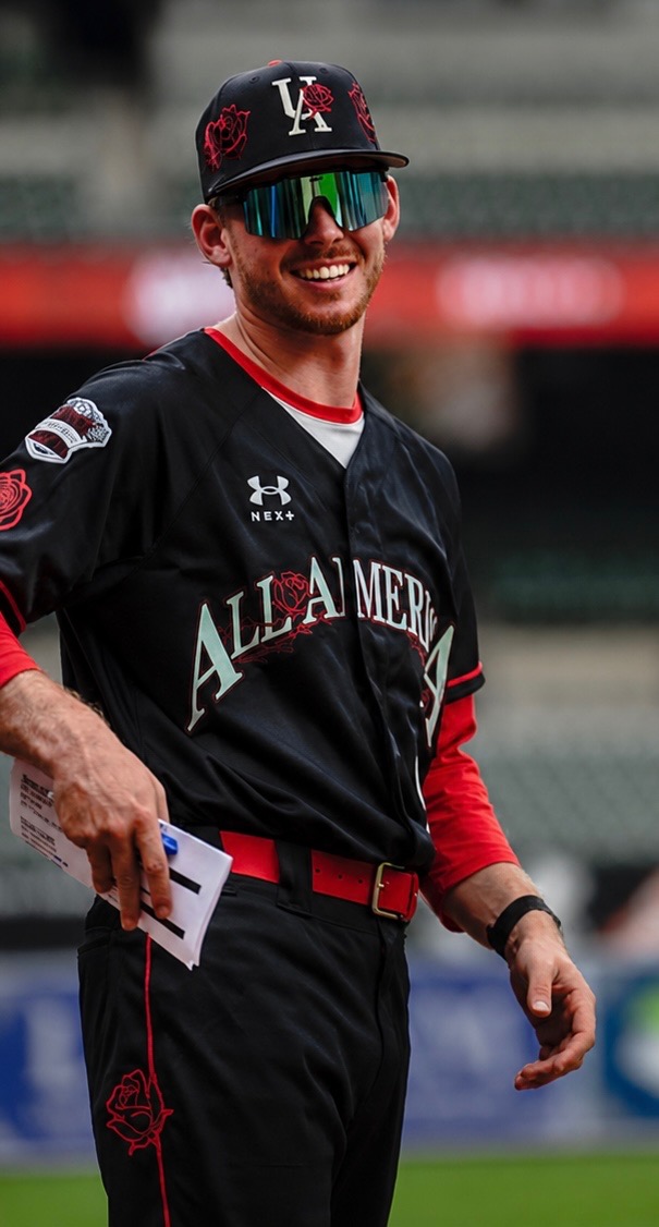 Tristan McAlister smiling in an All-America baseball uniform
